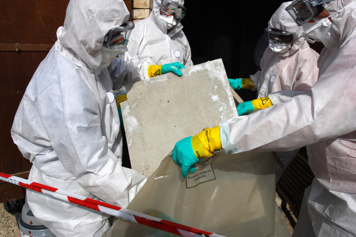Asbestos cement sheets being removed safely